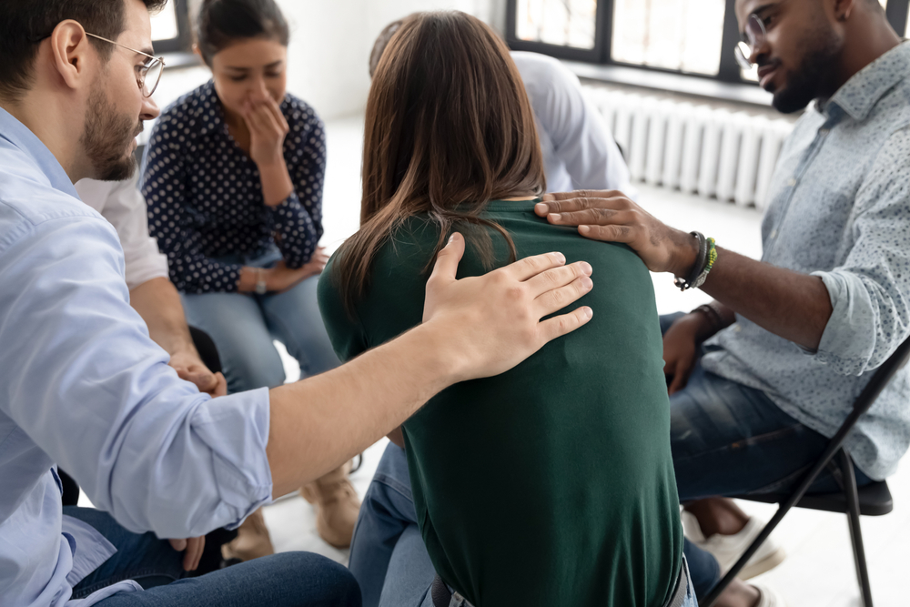 Multi,Ethnic,People,Gathered,Together,Sitting,On,Chairs,In,Circle